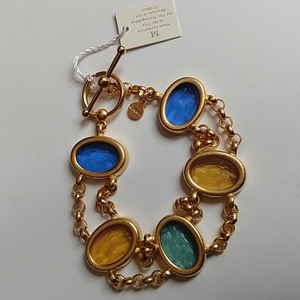 Nwt Retired MMA gold-plated bracelet with glass intaglios.